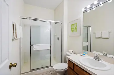 a bathroom with a shower and a toilet and a sink at 7719 Comrow in Kissimmee