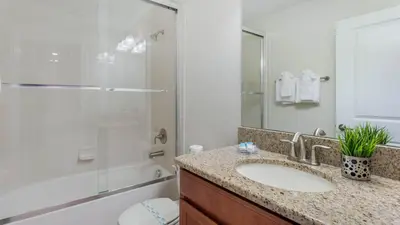 a bathroom with a sink and a shower at 4741 Kings Castle C in Kissimmee