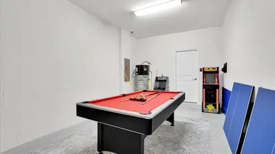 a ping pong table in a room with a pool table at 4741 Kings Castle C in Kissimmee