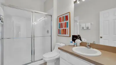 a bathroom with a shower and a toilet and a sink at 7739 Comrow in Kissimmee