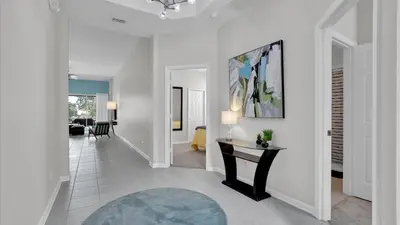 a hallway with a table and a living room at 7739 Comrow in Kissimmee