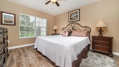 a bedroom with a bed and a ceiling fan at 7740 Comrow in Kissimmee