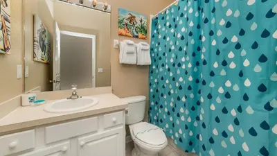 a bathroom with a toilet and a sink and a shower at 7740 Comrow in Kissimmee