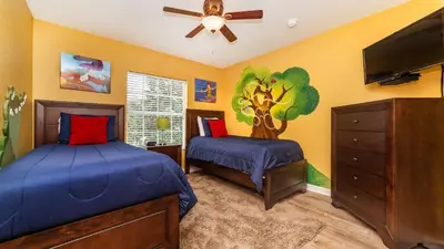 a bedroom with two beds and a flat screen tv at 7740 Comrow in Kissimmee