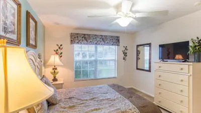 a bedroom with a bed and a ceiling fan at 2633 Daulby in Kissimmee