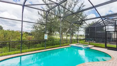 a swimming pool in a building with a glass wall at 2633 Daulby in Kissimmee