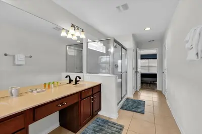 a bathroom with a sink and a mirror at 7756 Grassendale in Kissimmee