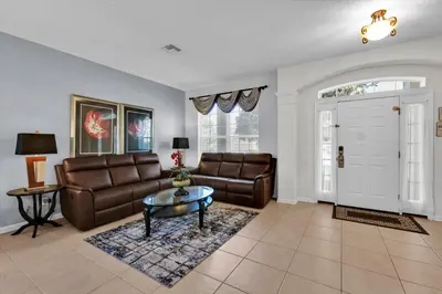 a living room with a couch and a table at 7756 Grassendale in Kissimmee