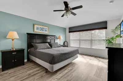 a bedroom with a bed and a ceiling fan at 7756 Grassendale in Kissimmee
