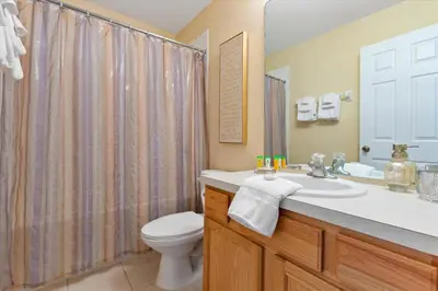 a bathroom with a sink and a toilet and a shower at 2678 Manesty in Kissimmee