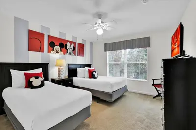 a bedroom with two beds and a television in it at 2702 Manesty in Kissimmee