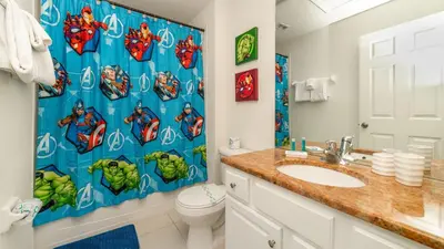a bathroom with a superhero shower curtain and a toilet at 2537 Maneshaw in Kissimmee