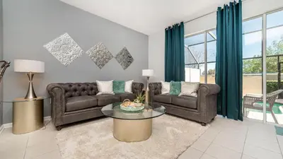 a living room with two couches and a table at 2537 Maneshaw in Kissimmee