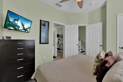 a bedroom with a bed and a tv on the wall at 2549 Maneshaw in Kissimmee