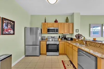 a kitchen with wooden cabinets and stainless steel appliances at 2549 Maneshaw in Kissimmee