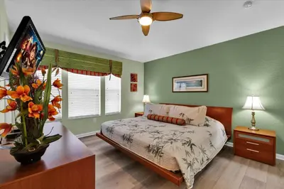a bedroom with a bed and a ceiling fan at 2549 Maneshaw in Kissimmee