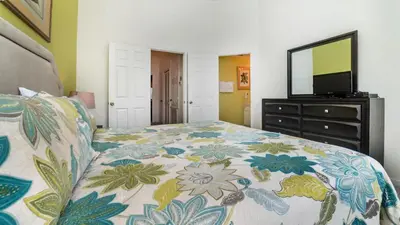 a bedroom with a bed and a television on a dresser at 7678 Otterspool in Kissimmee