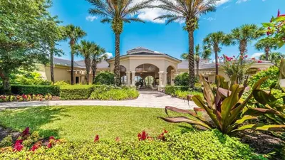 a house with palm trees and a garden at 2605 Pawnall in Kissimmee