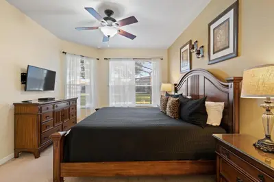 a bedroom with a bed and a ceiling fan at 2605 Pawnall in Kissimmee