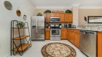 a kitchen with wooden cabinets and stainless steel appliances at 2508 Renshaw in Kissimmee