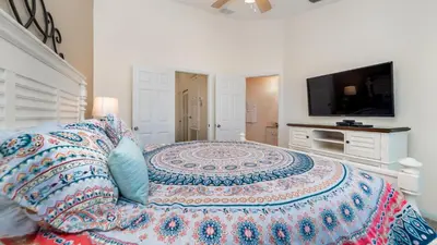 a bedroom with a large bed and a flat screen tv at 2508 Renshaw in Kissimmee
