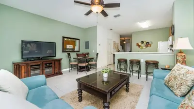 a living room with a blue couch and a tv at 2540 Renshaw in Kissimmee