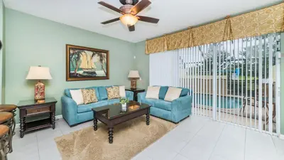 a living room with a couch and chairs and a fan at 2540 Renshaw in Kissimmee