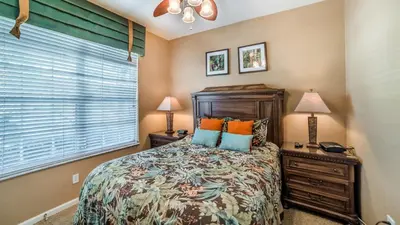 a bedroom with a bed and two lamps and a window at 2540 Renshaw in Kissimmee