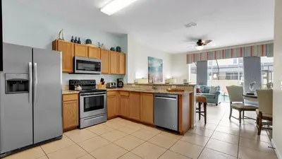 a kitchen with wooden cabinets and stainless steel appliances at 7653 Sir Kaufmann in Kissimmee