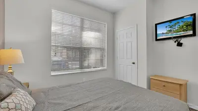a bedroom with a bed and a flat screen tv at 7679 Sir Kaufman in Kissimmee