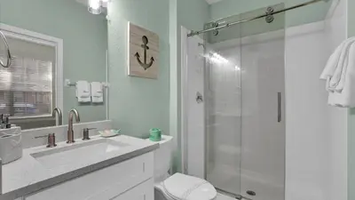 a bathroom with a shower and a sink and a toilet at 7679 Sir Kaufman in Kissimmee