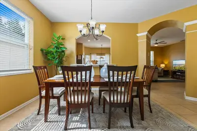 a dining room with a table and chairs at 7718 Teascone in Kissimmee