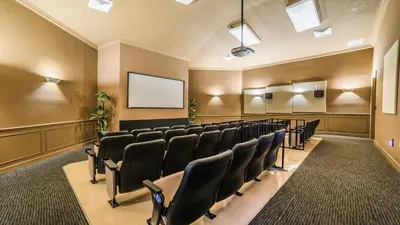 a conference room with chairs and a screen at 7718 Teascone in Kissimmee