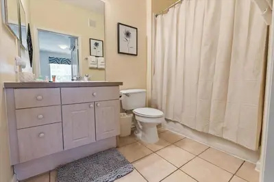 a bathroom with a toilet and a sink and a shower at 8107 Coconut Palm #305 in Kissimmee