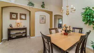 a dining room with a table and chairs at 8147 Fan Palm in Kissimmee