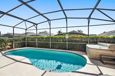 a swimming pool in a tent with a hot tub and a bath tub at 8157 Fan Palm in Kissimmee