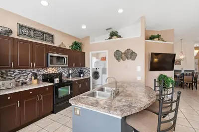 a kitchen with brown cabinets and a counter top at 8157 Fan Palm in Kissimmee