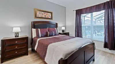 a bedroom with a large bed and a window at 8159 Fan Palm in Kissimmee