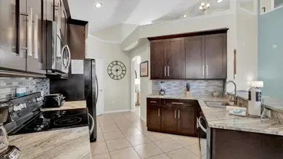 a kitchen with wooden cabinets and a stove top oven at 8176 Fan Palm in Kissimmee