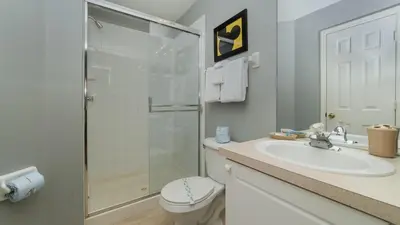 a bathroom with a shower and a sink and a toilet at 8208 Fan Palm in Kissimmee