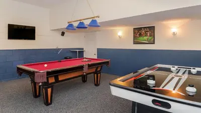 a room with a pool table and a tv at 8008 King Palm in Kissimmee