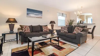 a living room with two couches and a table at 8008 King Palm in Kissimmee