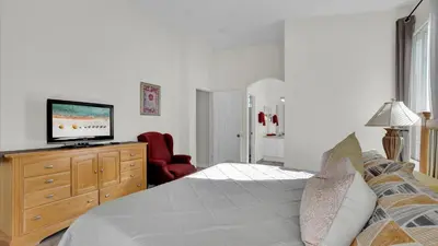 a bedroom with a bed and a television on a dresser at 8034 King Palm in Kissimmee