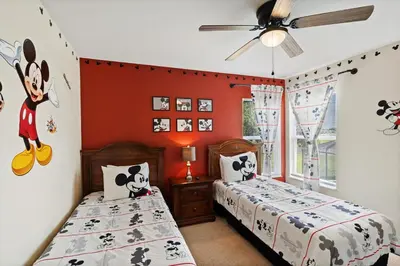 two beds in a bedroom with red walls at 8038 King Palm in Kissimmee