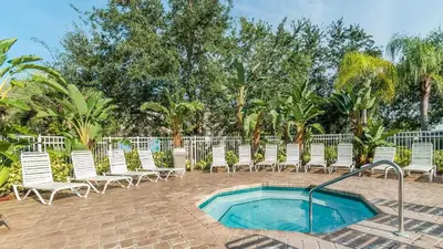 a group of chairs and a swimming pool at 8114 Princess Palm in Kissimmee