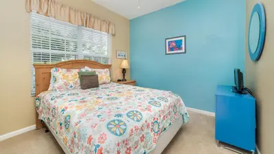 a bedroom with a bed and a window and a television at 8114 Princess Palm in Kissimmee