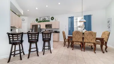 a kitchen and dining room with a table and chairs at 8135 Sun Palm in Kissimmee
