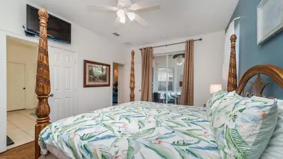 a bedroom with a bed and a ceiling fan at 8136 Sun Palm in Kissimmee