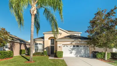 a palm tree in front of a house at 8136 Sun Palm in Kissimmee