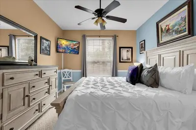 a bedroom with a bed and a ceiling fan at 2302 Silver Palm # 103 in Kissimmee